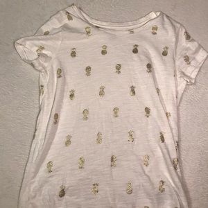 A white and gold pineapple shirt